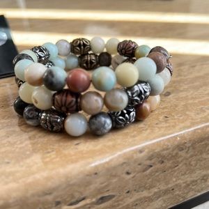 A one of a kind handmade wrap bracelet with blue, green, brown and metal beads